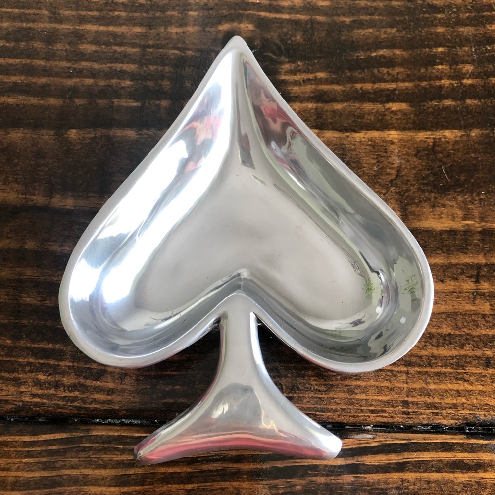 Silver plate. Looks exactly like the Kate spade heart brand